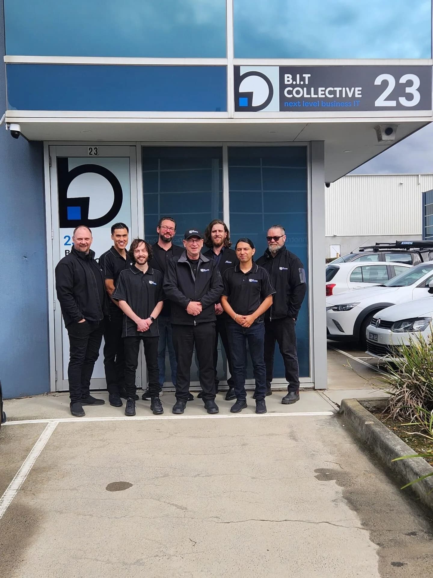 B.I.T Collective team photographed outside the branded office entrance