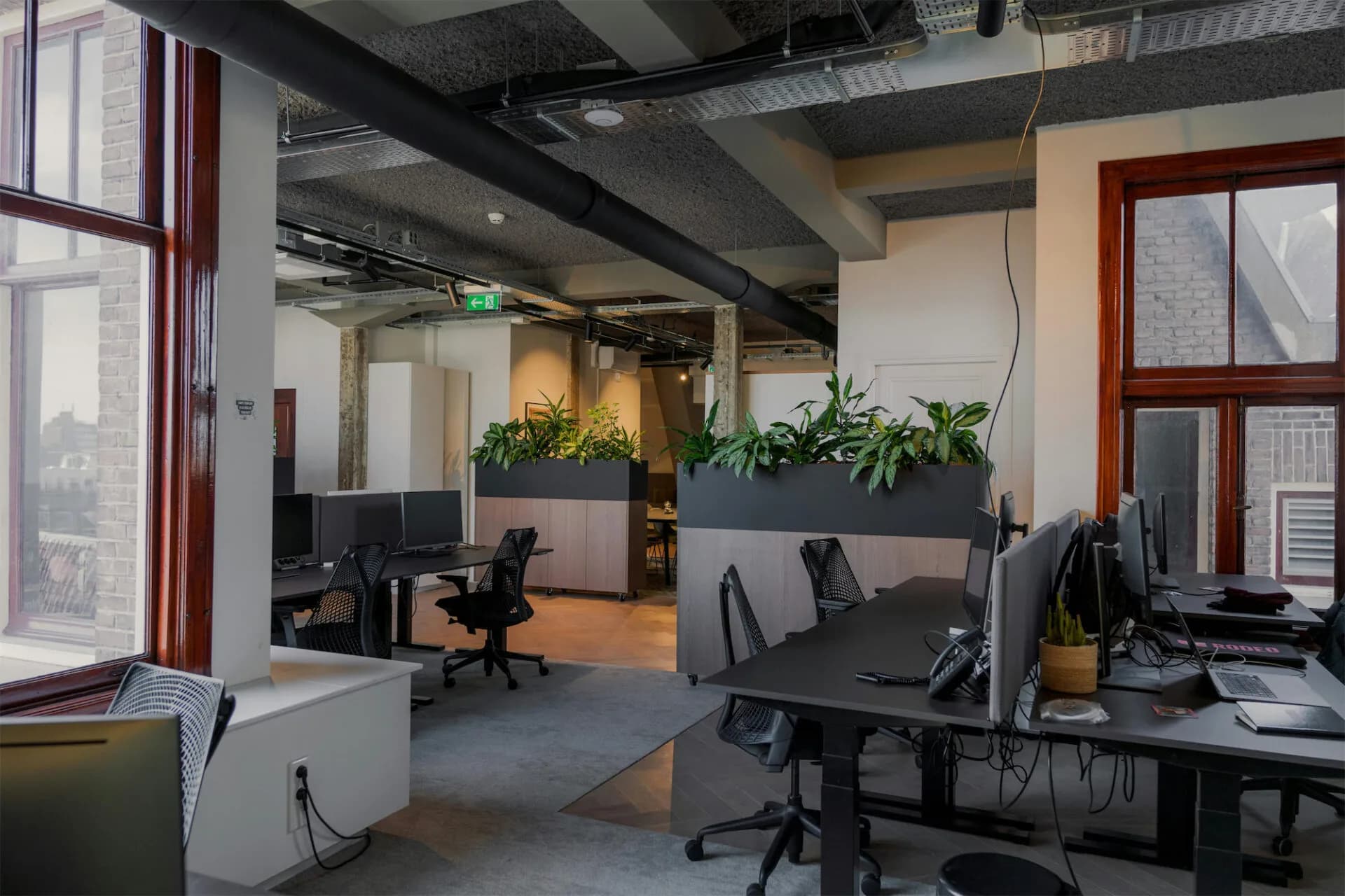 Office workstations with computer monitors and shared desk areas
